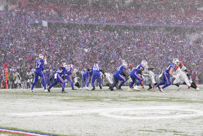 The Buffalo Bills play against the Cincinnati Bengals on a snowy field in Orchard Park.